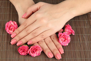 a manicure (pink fingernails)